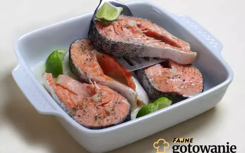 Soczyste kawałki łososia w naczyniu żaroodpornym, doprawione ziołami i skropione sokiem z limonki. Idealne przyprawy do łososia podkreślają jego smak.