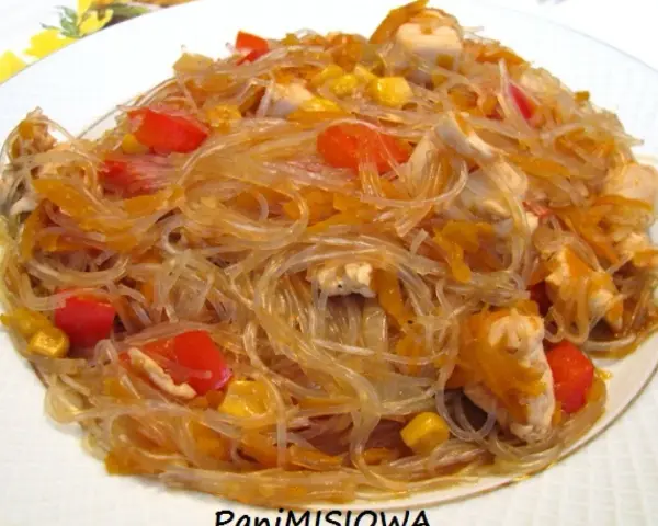 Pyszne danie z makaronem sojowym, kawałkami kurczaka, papryką i kukurydzą.